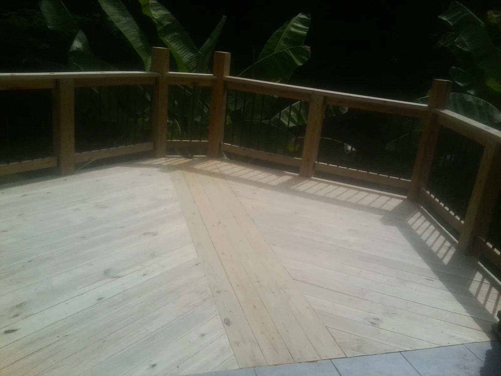 New wood deck and railing built off the back of a home in Worthington